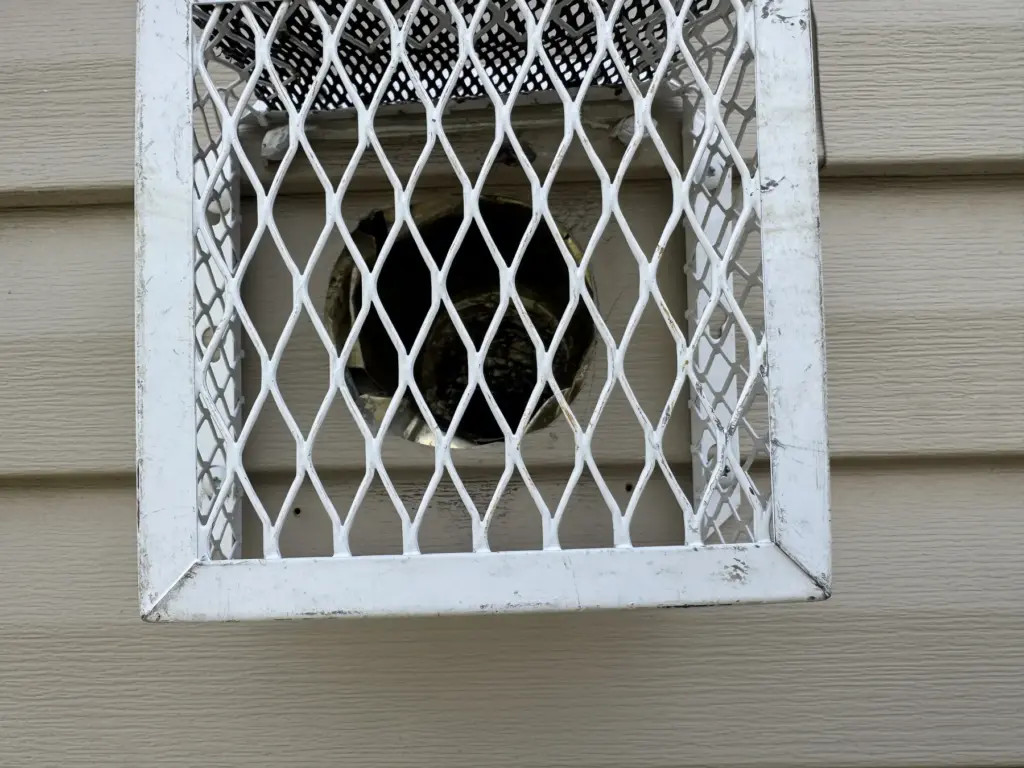 Bird-proof louver vent screen installed over an exterior opening in NYC