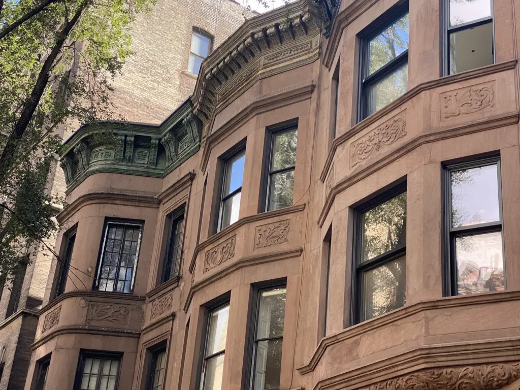 Close-up of bird spikes installed along an exterior ledge in NYC