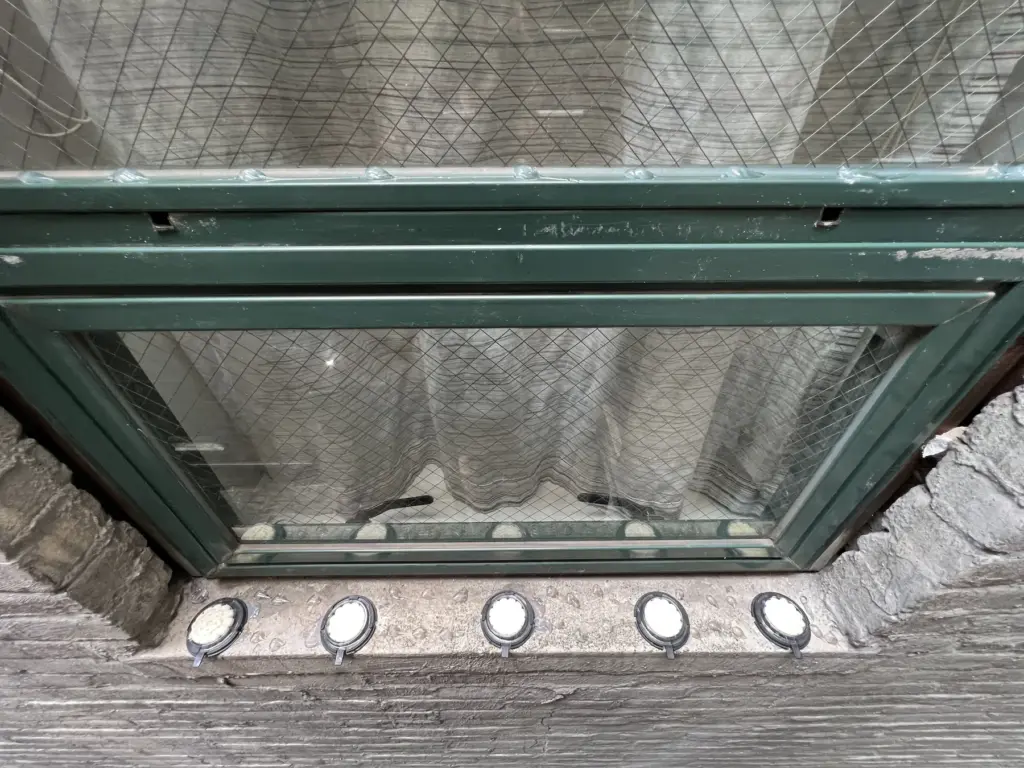 Optical bird gel deterrent installed near a fire escape and window ledge in NYC